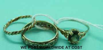 A tri-coloured ring, a 9ct gold ring set with smoky quartz and another 9ct gold ring (4.