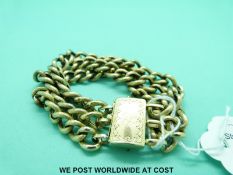 A yellow metal three strand curb link bracelet with rectangular engraved clasp (26.