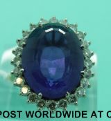 An 18ct gold ring set with a large oval mixed cut amethyst surrounded by diamonds (size O)