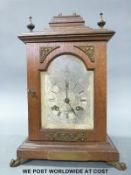 An oak-cased bracket style clock of small proportion,