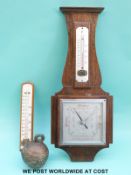 A c1930 aneroid wall barometer together with a thermometer and a brass elephant bell