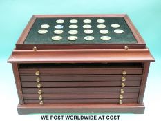 A coin chest containing 78 crown size coins, several being gold plated,