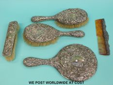 An Edwardian hallmarked silver mounted dressing table set comprising hand mirror,