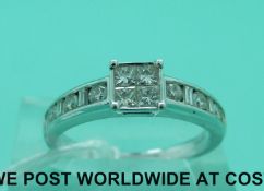 An 18ct white gold ring set with four princess cut diamonds and three round cut diamonds to each