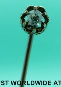 A Victorian stick pin set with an old cut diamond in a pierced setting