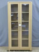 A glazed light oak display cabinet (W90 x D42 x H190cm)