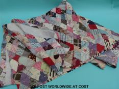 A patchwork quilt with floral and stitch work decoration to the reverse,