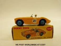 Dinky Toys diecast model Austin Healey '100' Sports with yellow body and blue interior and hubs,