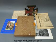 A case of German military and other medals in an Iron Cross-shaped display case,