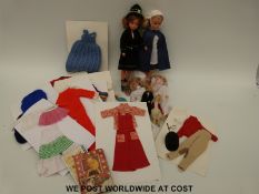 Two Sindy dolls together with various outfits and other dolls