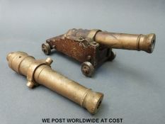 A brass and oak table or possible signalling camera on turned brass heels,