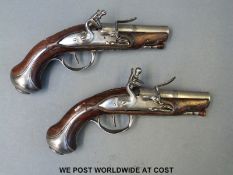 A pair of French flintlock hammer action pocket pistols with three inch steel barrels and ornately