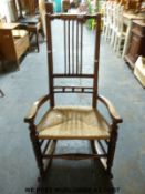 A 19th century oak and fruitwood rush seated rocking chair
