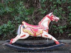 A 19thC / 20thC rocking horse on curved base decorated all over in orange and red,