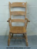 A 19thC elm seated Windsor armchair.