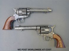 A pair of metal .45 Army replica six-shot revolvers.