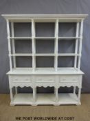 A painted three drawer dresser with shelves above,
