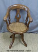 Early 20th century bergere seated office chair with shaped and curved frame.