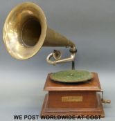 A vintage gramophone with brass horn, with label for The Gramophone and Typewriter, 21 City Road,