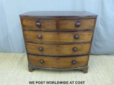 A 19th century bow front chest of two over three drawers with turned bun handles (W101 x D53 x