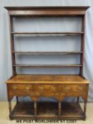 A Georgian oak dresser with plate rack above,
