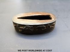 Japanese Edo period fuchi decorated with temple dogs and auspicious symbols on hammered ground.