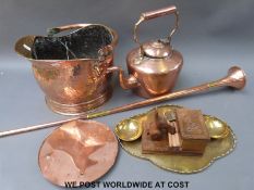 A hammered copper scuttle, copper kettle, carved novelty cigarette dispenser,