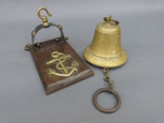 A brass military interest bell on wall bracket