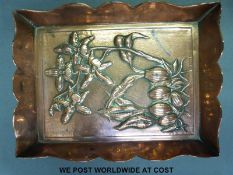 A copper embossed dish decorated with flowers in the Arts and Crafts style stamped Rd52155