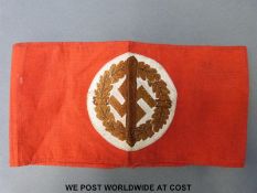 A Nazi German armband with wreath and sword across swastika