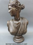 A bronzed bust of a classical maiden