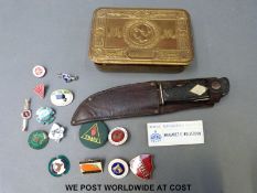 A sheath knife in leather sheath having further tools to handle,