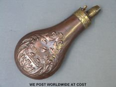 Copper powder flask with embossed decoration in the form of birds amongst foliage and brass mount.
