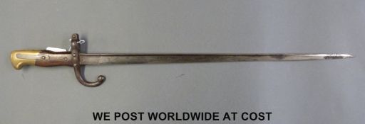 A French 1874 bayonet with wood and brass grips,