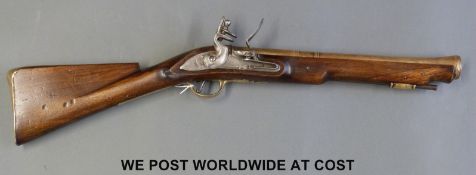 A flintlock brass barrelled blunderbuss with 16 inch part octagonal barrel stamped to the top 'HMS