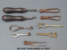 Nine shotgun cartridge decappers, bullet moulding and similar tools.