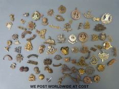 A collection of British military insignia and helmet plate centres,