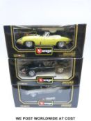Three Burago 1:18 scale diecast model 1961 Jaguar E-type sports cars, two Coupes and one Cabriolet,