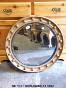 A circular bevelled glass mirror,