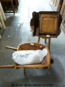 A child's wooden wheelbarrow,