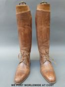 A pair of vintage brown leather riding boots complete with wooden trees, approximately size 11,