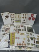 A box of world military badges and insignia to include fabric,