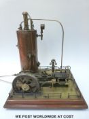 A stationary live steam engine with vertical boiler, horizontal single cylinder engine,