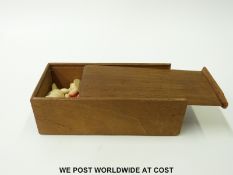 A late 19th/ early 20thC carved bone chess set, one side stained in red,