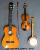 A child's cased violin complete with bow together with a half size acoustic guitar and a ukulele