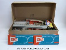 A collection of Trix, Hornby and other 00 gauge carriages, wagons, buildings and accessories,