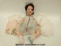 A German bisque headed doll with open mouth, weighted brown eyes,