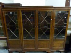 An early 20th century style astragal glazed breakfront mahogany bookcase.