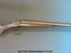 Unnamed 12 bore double barrelled side by side hammer action shotgun with engraving to the side