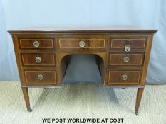 A late 19th / early 20th century desk with seven variously sized drawers,